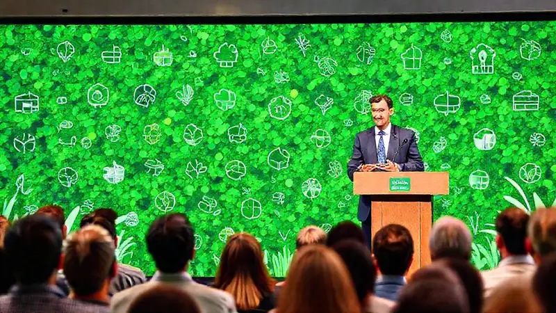 Orador confiado en escenario ecológico profesional