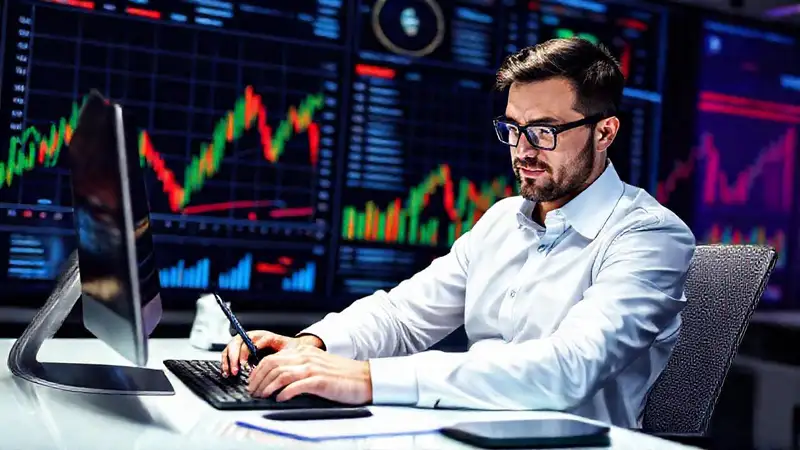 Economista programando con gráficos financieros en fondo